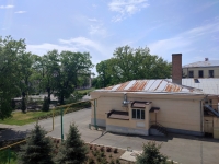 На территории ЮРГПУ (НПИ). Вид на здание столовой с бассейна. Слева за деревьями - главный корпус